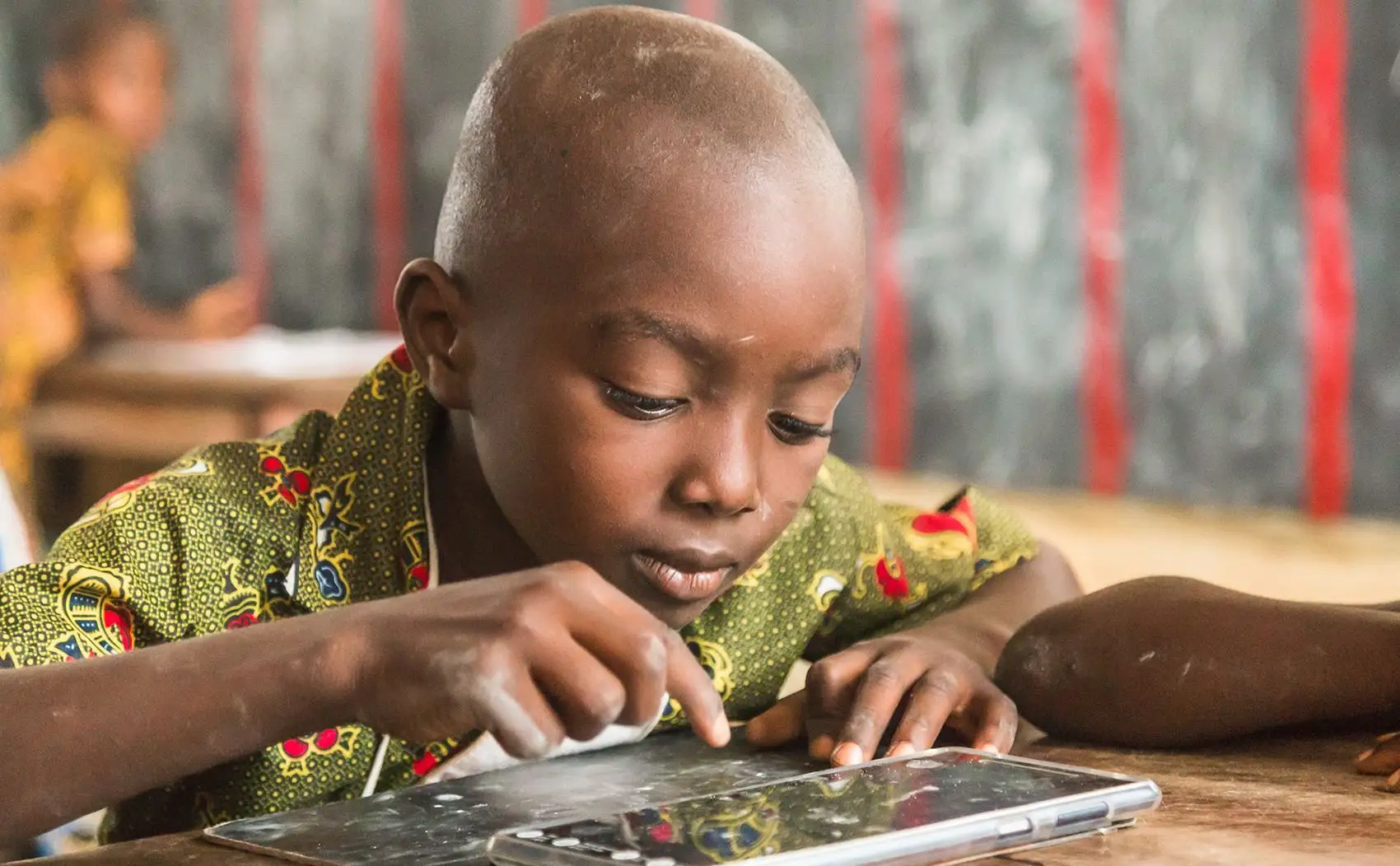 A student works on a tablet computer in a classroom